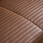Its flowing lines seamlessly blend the backrest and armrests, offering a generous seat depth