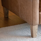 The pretty blond legs elegantly extend the sofa.