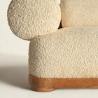 Its solid oak base encircles a deep seat, designed to envelop and provide lasting support