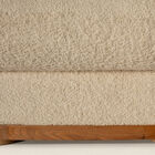 The cylindrical armrests and low backrest form a continuous line