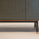 It combines a smooth walnut outer frame with four carved fronts