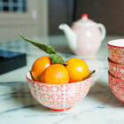 Four bowls with geometric patterns of a bright red.