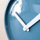 The clock is refined, blue with white hands.