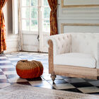 The linen and wood armchair has a certain charm.