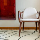 This armchair combines a dark brown solid ash base with an ecru bouclette upholstery