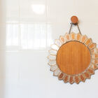 Mirror with scalloped edges in gilded brass.