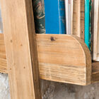 The shelf has vertical borders to hold objects.