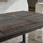 This coffee table features a monochromatic geometric structure where metal frames the organic