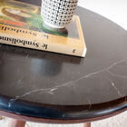 Its compass legs refer to furniture produced in the early twentieth century