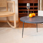 Superb round coffee table with a thick black marble top.