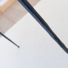 Very thin legs in matt black metal, textured and extremely strong.