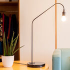 Matt black cylindrical brass rod with a stable and circular base.