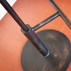 It has a brushed metal base and a solid footrest