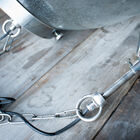 The suspension is maintained by a black cable and a metal chain.