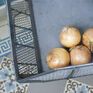 A metal basket that takes care of its onions.