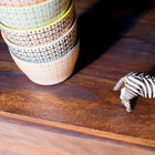 The shelf has a varnish to protect the wood.