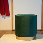 Deep green velvet pouf with a golden base.