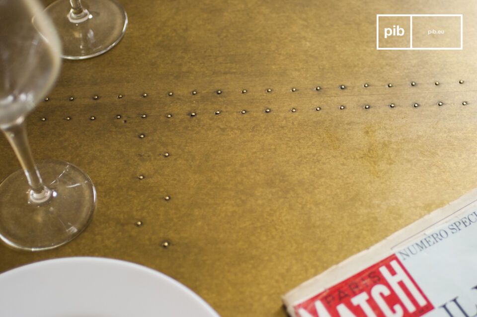 The table top is made out of oak wood covered with a thick lacquered brass and stud with nails