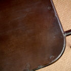 a tubular structure and a very dark, almost black patina.