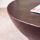 The surface of the table is hammered with small irregular streaks.