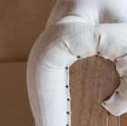 The fabric is fixed to the structure by nails whose heads have been left visible