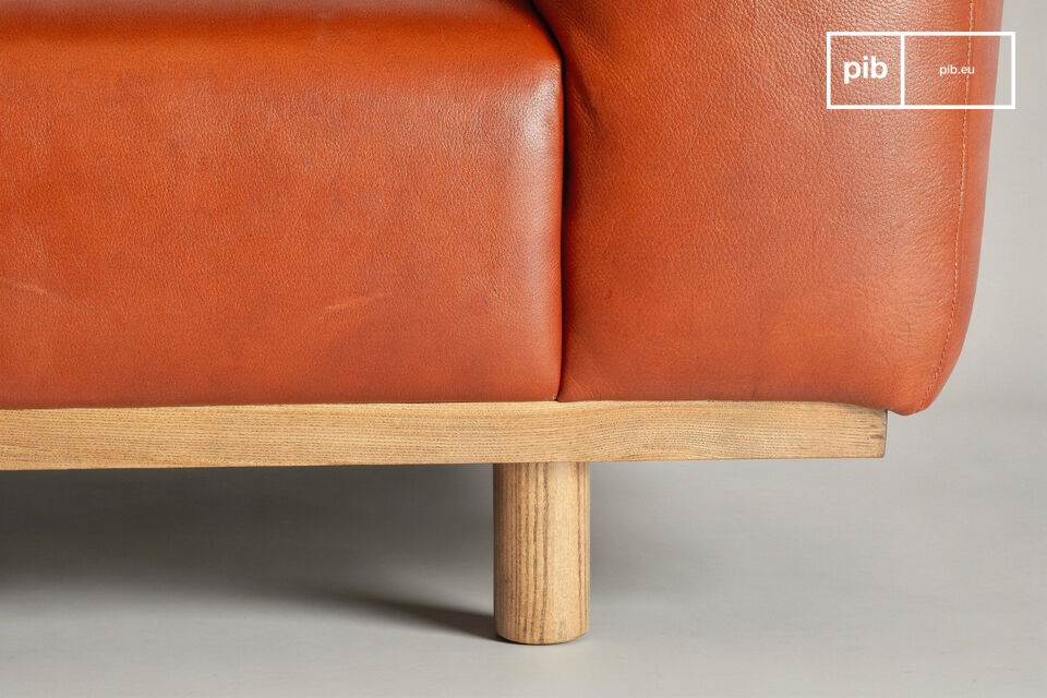 The seat is upholstered in full-grain aniline leather that reveals the life of the material