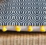 Pretty black and white geometric patterns cover the cushion.