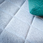 The grey wool fabric is soft to the touch.