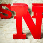 Sign letter N in patinated red metal.