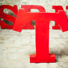 Red patinated metal workshop letter.