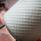 The graphic motifs and the vintage style of the object are enhanced by the tactile design