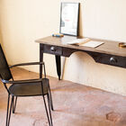 The office combines a rosewood top and a steel base.