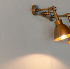 A double wall lamp in patinated brass