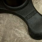 Dark cast iron stamped with the inscription