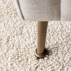 The design of the Elbrouz sofa features slightly flared feet in patinated brass