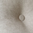 The central button on the backrest and the piping marking the edges add a touch of sophistication