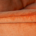 The central buttons on the back cushions and the piping that highlights the edges add a