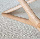 The clean lines of the legs are accentuated by the light wood.