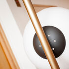 It rests on a round, black, slightly ribbed marble base