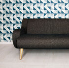 This distinctive sofa with a solid oak leg frame and broad rounded armrests can boast a heritage