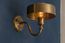 The Amber golden brass wall lamp brings a touch of warmth and a soft atmosphere to your home's