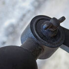 Rivet type screw that connects the base to the neck of the luminaire.