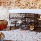 A large shoe bench with 15 storage spaces.