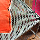 The seat of the bench is perforated with many pretty little holes.