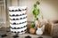 Beautiful white laundry basket with black patterns.