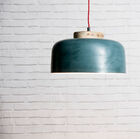 A suspended luminaire in a greyish blue colour.