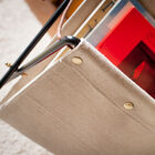 The reverse side of the magazine holder is closed with pretty gold rivets.