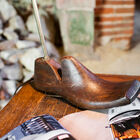 The metal part of the lamp gushes out of the heel of the shoe.