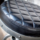 The leather seat has elegant geometric markings.