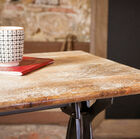 the thin top contrasts with the very industrial vintage side of the base.